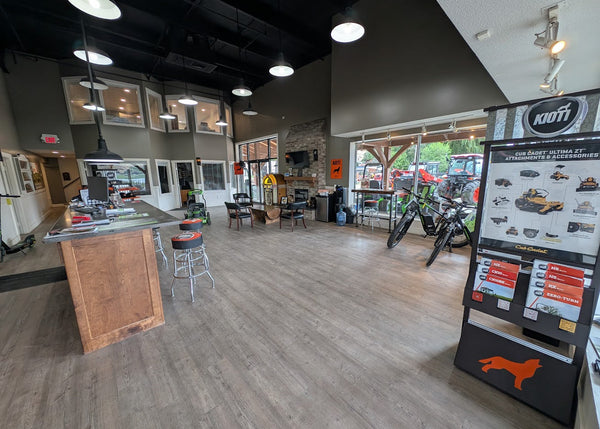 Indoor showroom with Kioti equipment display and wooden counter